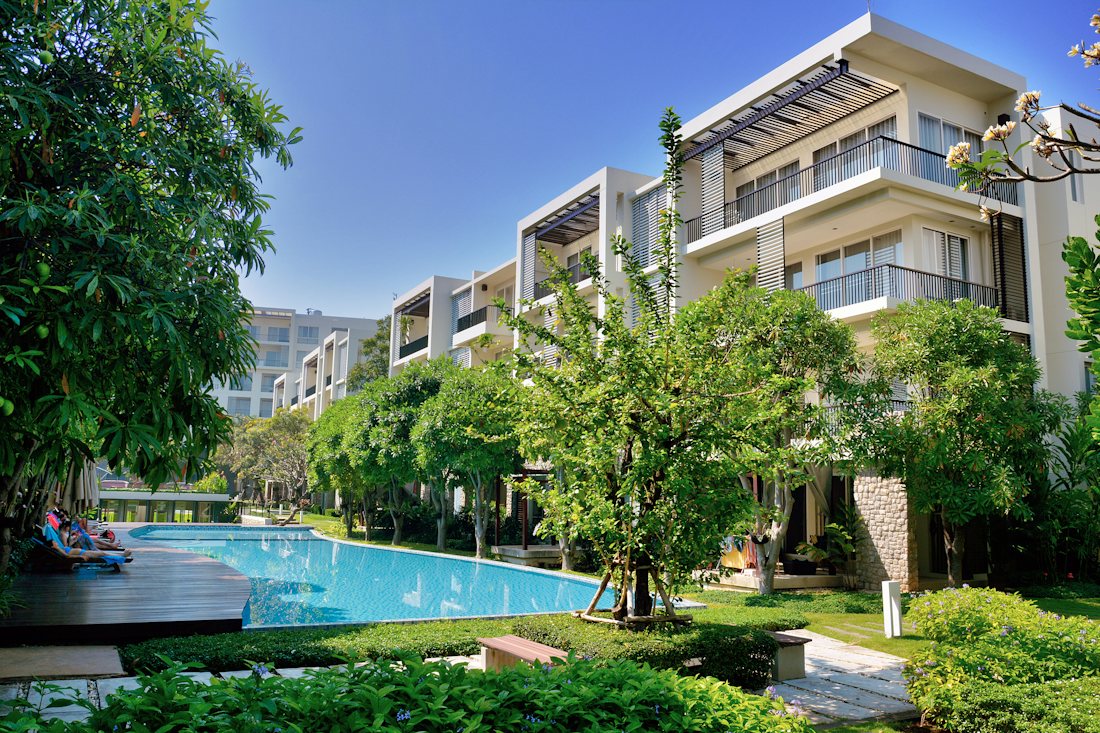 Residential buildings with gardens and a pool